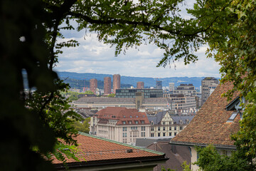 Zurich skyline with modern and historic buildings framed by trees