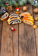 poppy and walnut roll cakes, santa and angel decorations, pine branch garland, old wood table