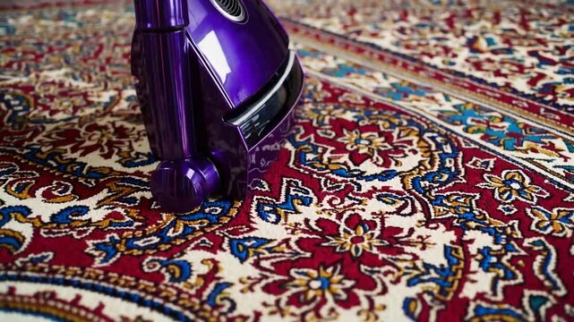 Lavender-Colored Upright Vacuum Cleaner Positioned Upon Exquisitely Patterned Antique Area Rug