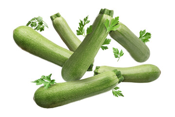 Fresh zucchinis and parsley falling on white background