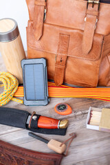 Camping gear with leather backpack, solar charger, knife, compass, rope, thermos, survival...