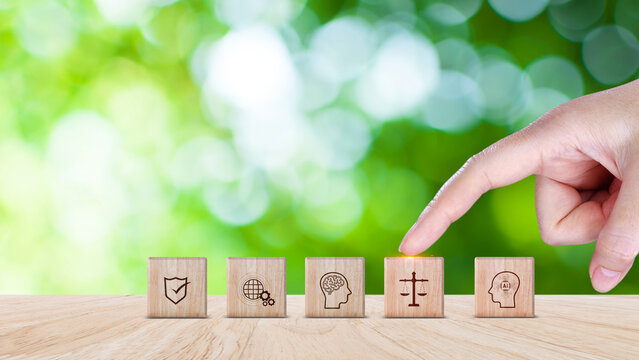 AI ethics or AI law concept. balancing artificial intelligence with humanity, Icons related AI ethics on wooden cube, symbols of legal scales, security, ethical 