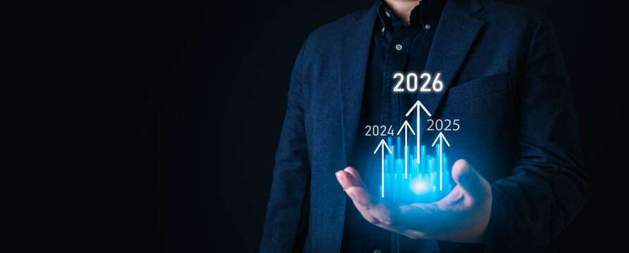 Future growth concept with businessman holding glowing bar chart and arrows pointing to years 2026, symbolizing financial success, economic progress, and strategic planning.