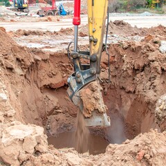 Fototapeta premium Excavator digging a hole in the ground (1)