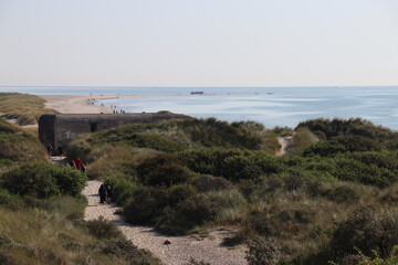 People at the walking trail to the sandbar spit Grenen where the Skagerrak (part of the North Sea)...