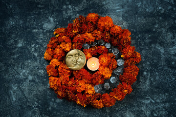 moon amulet and burning candle, quartz crystals, orange marigold flowers on abstract dark...