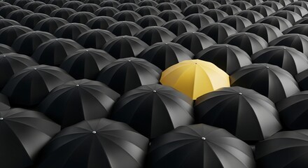 A single bright yellow umbrella stands out prominently in a large crowd of identical black umbrellas, symbolizing individuality and uniqueness.