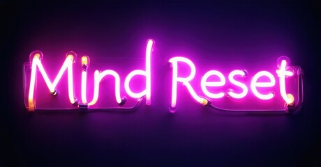 Bright pink neon sign displays words Mind Reset against dark purple background. Simple, modern aesthetic.