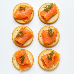 top view of crackers with smoked salmon and dill, isolated on white background