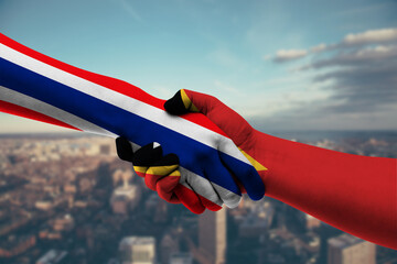 Shaking hands Thailand and East Timor