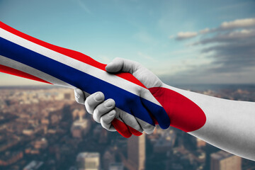 Shaking hands Thailand and Japan