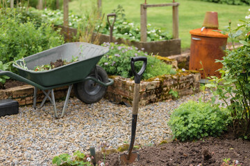 Authentic british countryside, focus on a shovel - gardening, farming themes, eco friendly, slow...