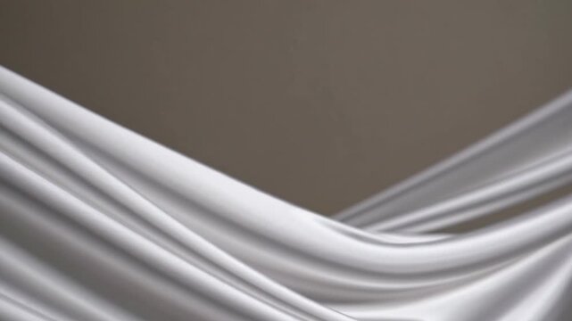 Elegant Textured White Fabric with Soft Drapes and Gentle Waves on Neutral Background This elegant white fabric features soft drapes and gentle waves, creating serene and sophisticated atmosphere. Pe
