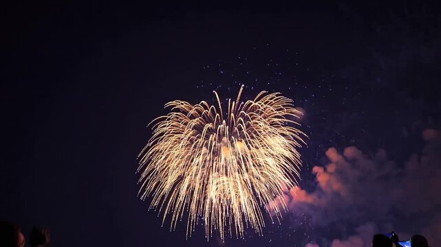 real fireworks display showing abstract blur of golden shining lights in the night sky