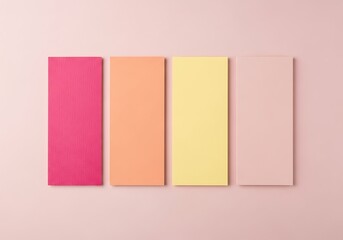 Fototapeta premium Four rectangular sticky notes in pastel colors on a pink background