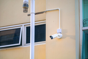 Security Camera Mounted on Yellow Wall