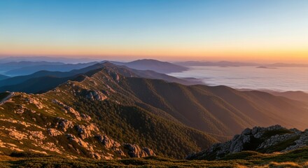 Majestic sunrise over mountain range with misty valley and endless horizon