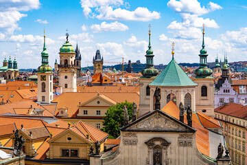 Panoramic view of old Prague with terracotta rooftops, cathedrals, towers, and the architectural lines of urban quarters.Prague,Czech Republic © Teo K