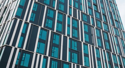 Modern high-rise building with geometric facade design and blue-tinted glass windows