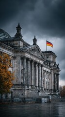Obraz premium Magnificent Reichstag building stands under dark clouds with German flag waving during a chilly day in Berlin