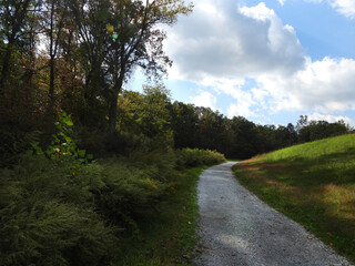 Fototapeta premium Visitors can enjoy the beautiful autumn scenery, while hiking the Hopewell Lake Loop Trail. French Creek State Park, Berks and Chester Counties, Elverson, Pennsylvania.