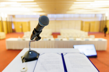 Microphone and Documents on a Podium in an Empty Conference Hall