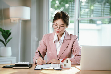 A woman hands over house keys with documents, symbolizing real estate contracts, property purchase, mortgage, investment, ownership, successful housing deals, and financial planning.
