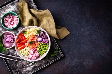 Balanced healthy bowl with vegetables and salmon