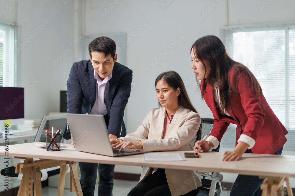 Aufkleber business team collaborating on a project while using laptops in a modern office space, engaging in d