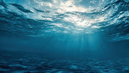 Obraz premium Underwater scene of sunlight penetrating deep blue water