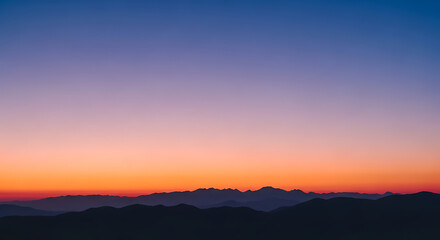 Fototapeta premium Breathtaking natural twilight colors paint the mountainous horizon, creating a serene and vibrant landscape view during sunrise or sunset, evoking a sense of peaceful wonder