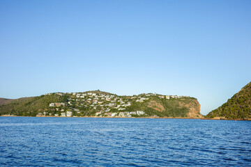 Beautiful cliffside community with houses built along green hills and rocky slopes overlooking the...