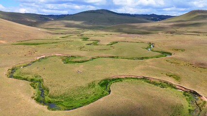 The Perşembe Yaylası is the summer pastureland of Perşembe district. Panoramic View of Meandering Stream and Majestic Mountains in Perşembe Plateau, Ordu, Turkiye.