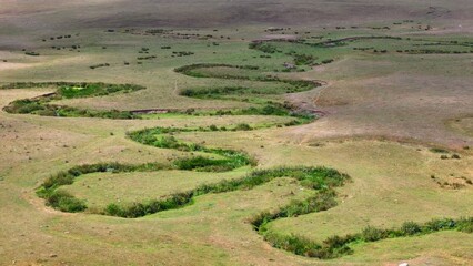 The Perşembe Yaylası is the summer pastureland of Perşembe district. Panoramic View of Meandering Stream and Majestic Mountains in Perşembe Plateau, Ordu, Turkiye.