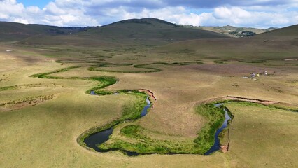 The Perşembe Yaylası is the summer pastureland of Perşembe district. Panoramic View of Meandering Stream and Majestic Mountains in Perşembe Plateau, Ordu, Turkiye.