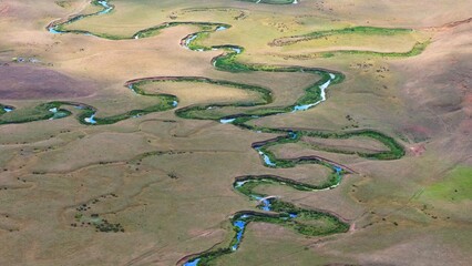 The Perşembe Yaylası is the summer pastureland of Perşembe district. Panoramic View of Meandering Stream and Majestic Mountains in Perşembe Plateau, Ordu, Turkiye.