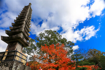 Adashino Nenbutsu-ji Temple in Arashiyama, Kyoto. A traditional Japanese stone pagoda with vibrant...