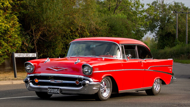 Whittlebury,Norhants,UK - Aug 23rd 2025:  1957 red Chevrolet Bel Air classic American  car driving on a British road
