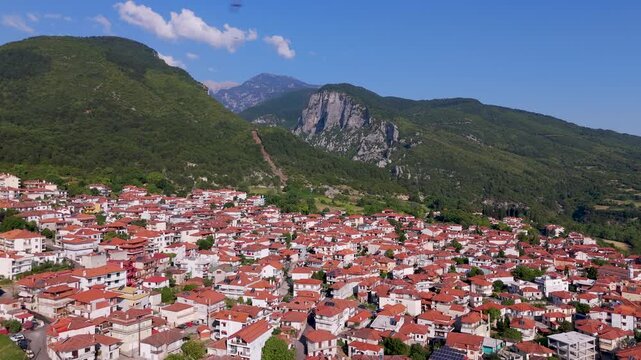 Aerial Drone Pan Over Litochoro Town with Mount Olympus in Pieria, Greece on a Summer Morning.