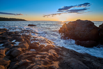 Sunset over the Bay of Fundy along a rocky shoreline, Nova Scotia Canada.