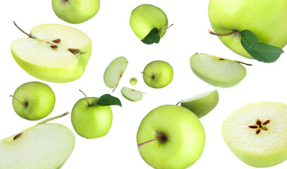 Fresh green apples swirling in air against white background
