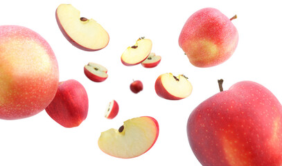 Fresh red apples swirling in air against white background