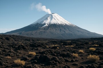 Snow-capped volcanic mountain emitting smoke with barren rocky terrain and sparse vegetation under clear blue sky in natural daylight. Ai generative