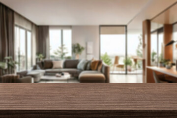 empty wooden table top blurred view of modern living room with sofa and soft bench. room interior with couch, armchair and coffee table or shelving units. stylish living room. comfortable workplace.