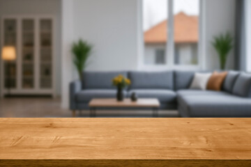 empty wooden table top blurred view of modern living room with sofa and soft bench. room interior...