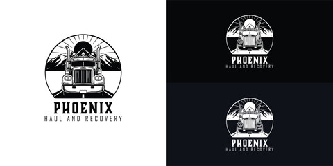 A classic black and white logo for a heavy haul towing company features a powerful semi-truck driving on a road toward a mountain range with the sun in the background.