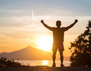 Silhouette of a triumphant man against a breathtaking sunset highlighting personal accomplishment