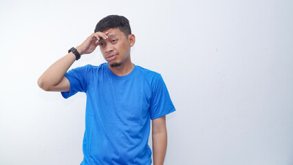 Asian man showing stress gesture with hand touching forehead