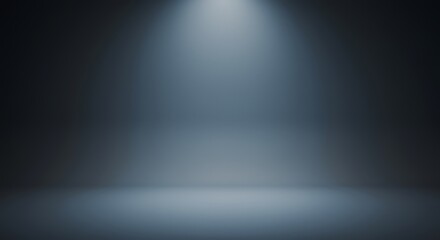 Spotlight shines down onto an empty stage or studio space with a dark blue gradient background.