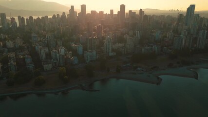 A slow aerial push into Vancouver's downtown core at dawn